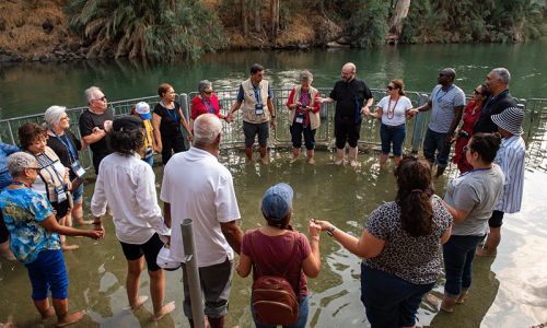 Pilgrims gathered in the waters of the Jordan River Baptism Ste.
