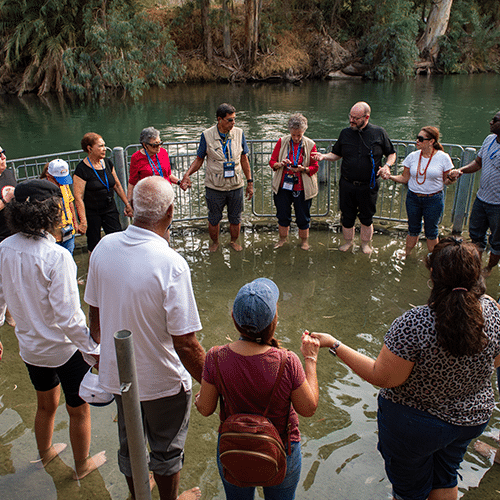 Pilgrims gathered in the waters of the Jordan River Baptism Ste.