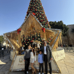Nativity CEO Khaled Jacoub and family in front of the Christmas Tree in Manger Square, Bethlehem