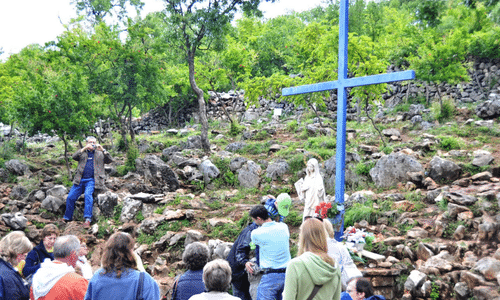 a revered, easily accessible pilgrimage site at the base of Apparition Hill (Podbrdo). Originally placed to mark where visionaries hid from communist police in the 1980s.