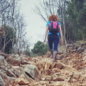 Pilgrim climbing the rocky path of Cross Mountain in Medjugorje