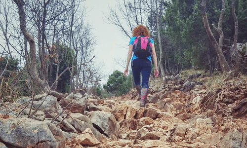 Pilgrim climbing the rocky path of Cross Mountain in Medjugorje