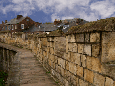 ancient stone wall stretching through the town of York, England