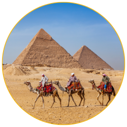 People riding camels in the Egyptian Desert in front of the Great Pyramids